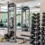 free weights and other exercise equipment in bright fitness center